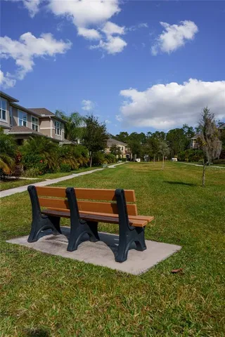 a park view with a bench in a garden