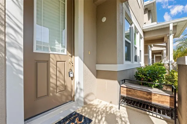 a front view of a house with outdoor seating and stairs
