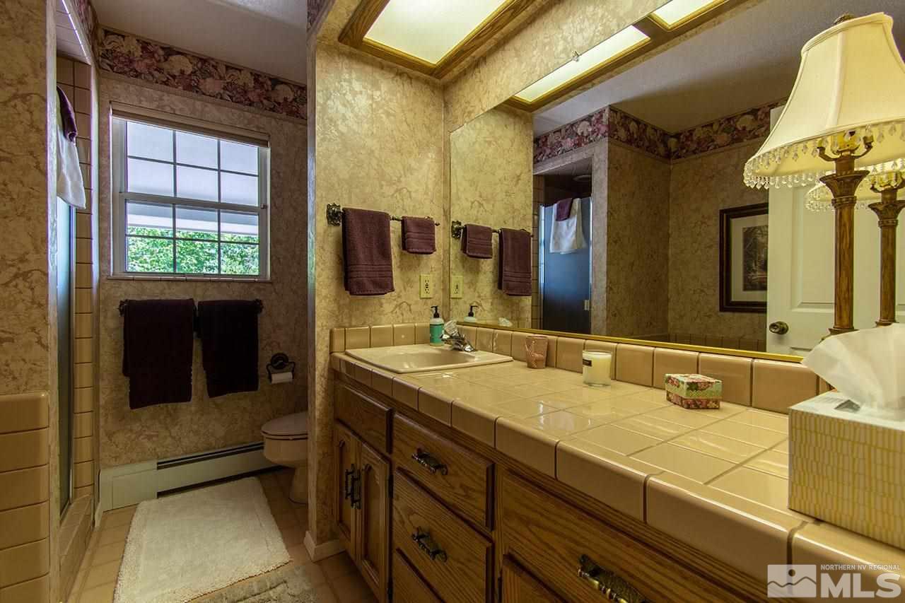 1155 Yates Lane Reno, NV 89509 - Photo 15 of 25 a bathroom with a sink and a mirror