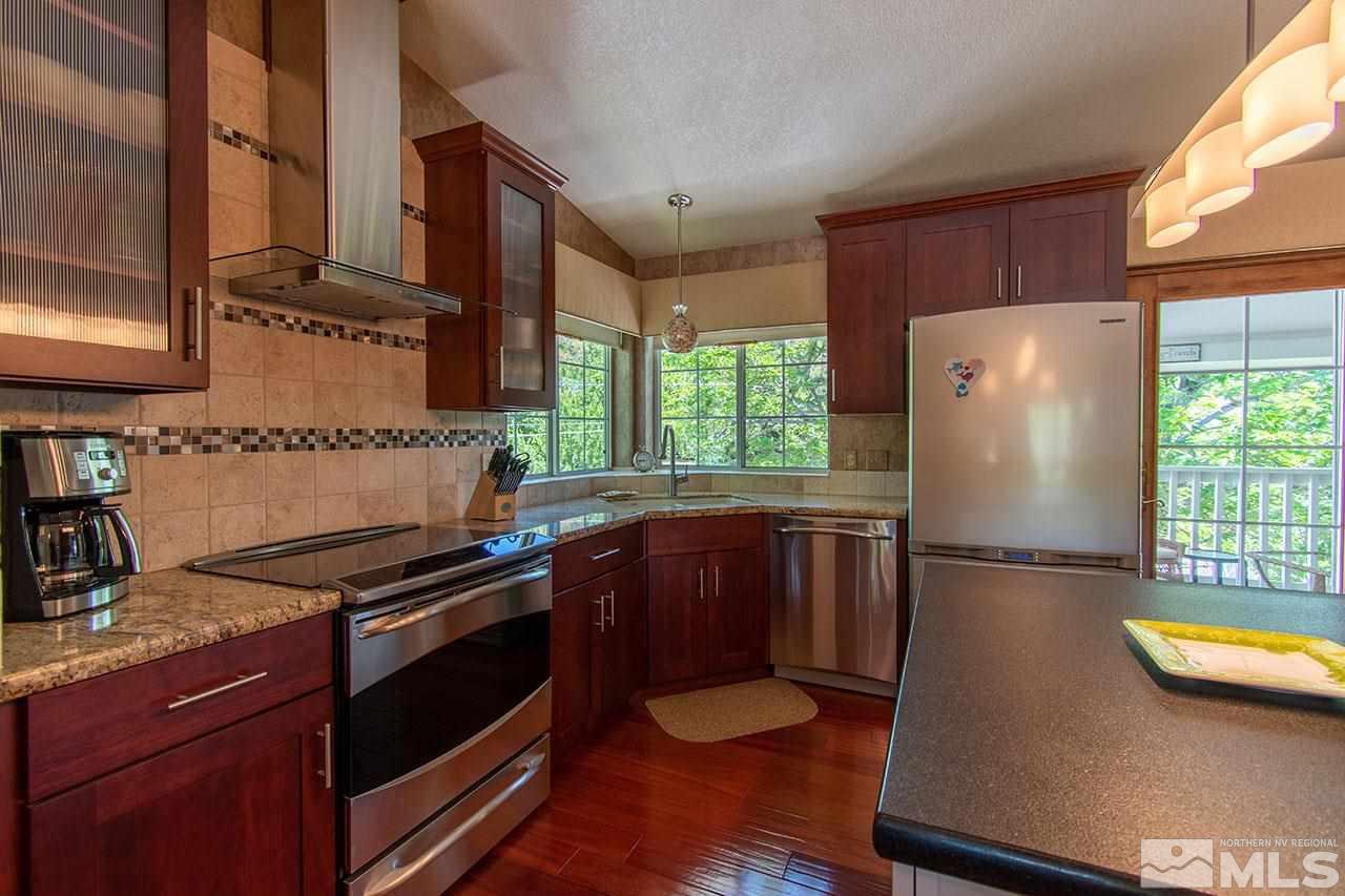1155 Yates Lane Reno, NV 89509 - Photo 8 of 25 a kitchen with stainless steel appliances granite countertop a refrigerator and a stove