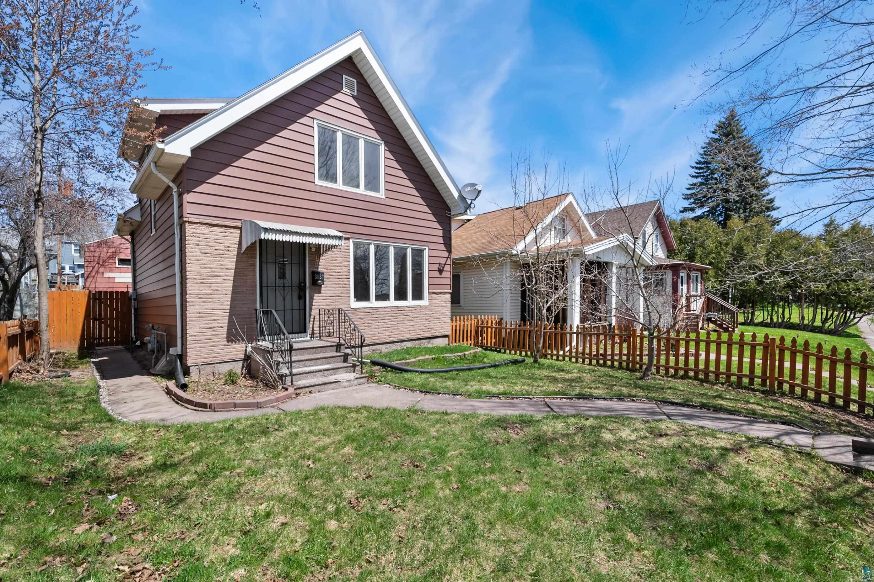 3067 Restormel Street Duluth, MN 55806 - Photo 1 of 25 Exterior facade featuring mixed siding, a stone base, and multiple windows