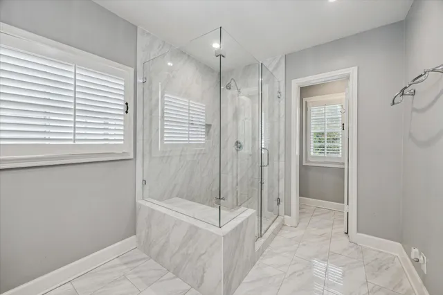 a bathroom with a shower and a sink