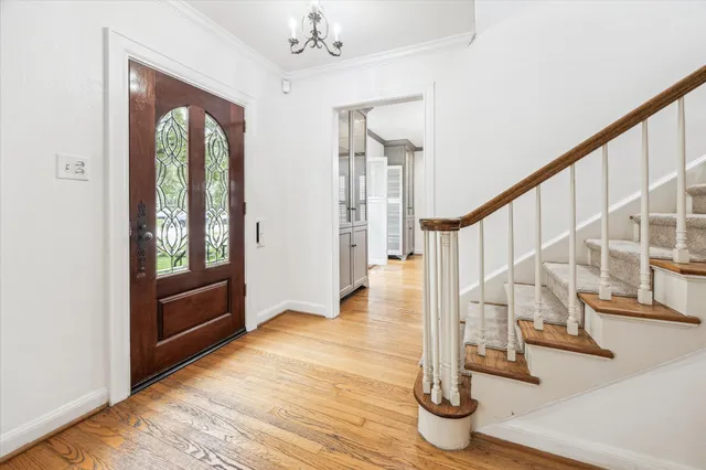 a view of entryway and hall with wooden floor