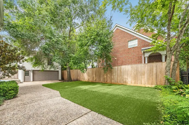 a front view of a house with a yard table and chairs