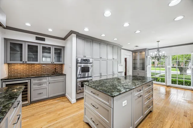 a kitchen with stainless steel appliances granite countertop a stove and a sink