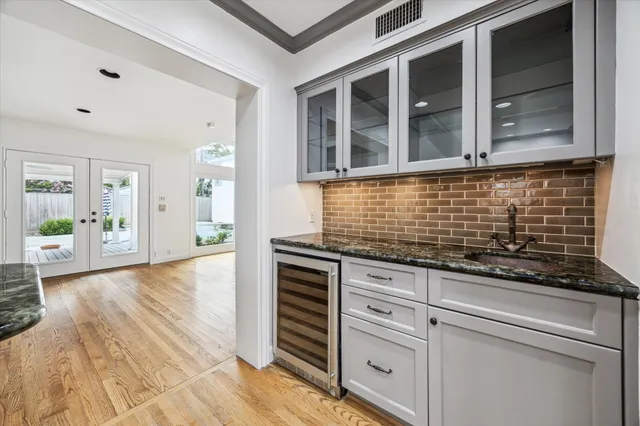 a kitchen with granite countertop white cabinets and white appliances