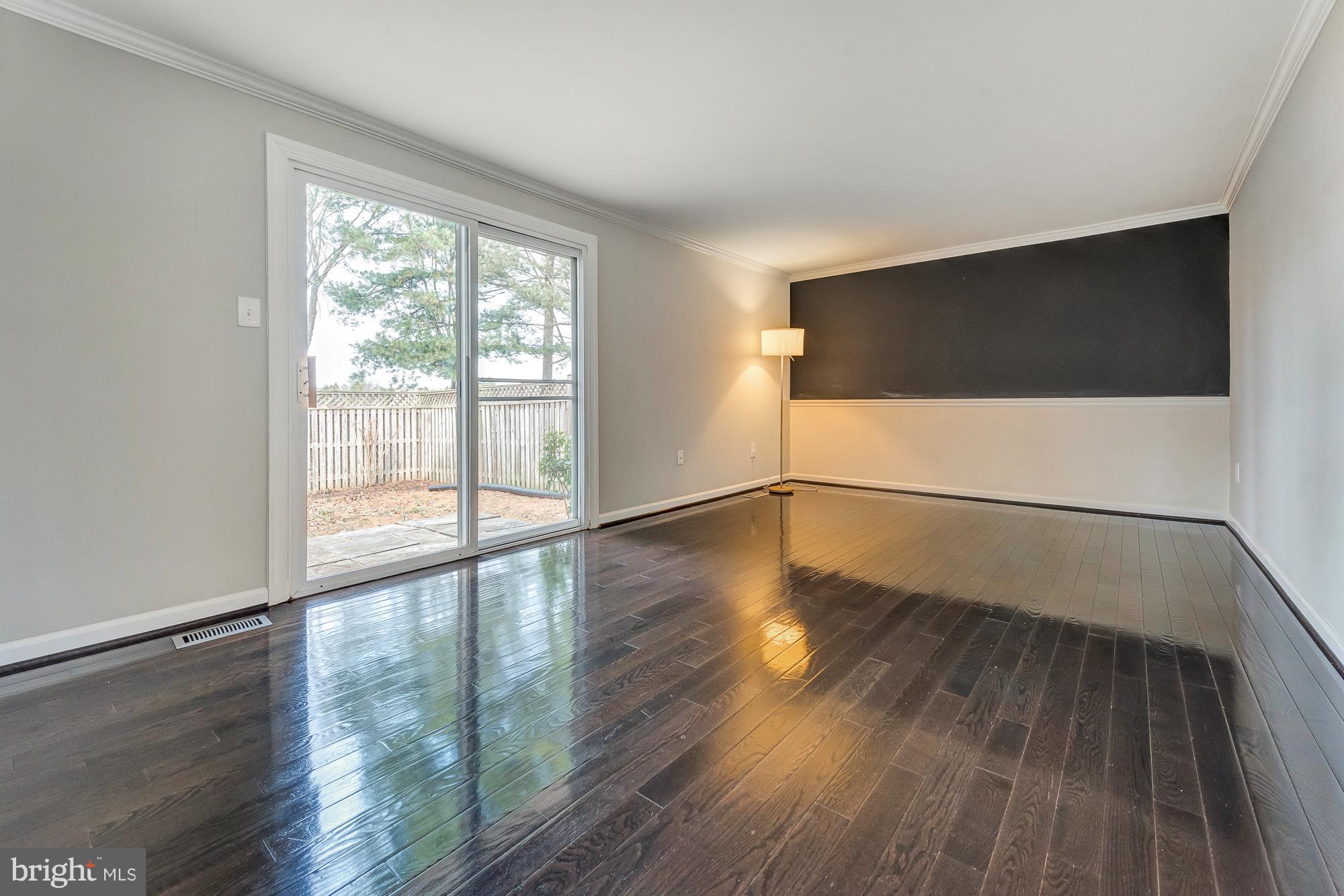 17624 Kohlhoss Road Poolesville, MD 20837 - Photo 15 of 36 a view of an empty room with wooden floor and a window