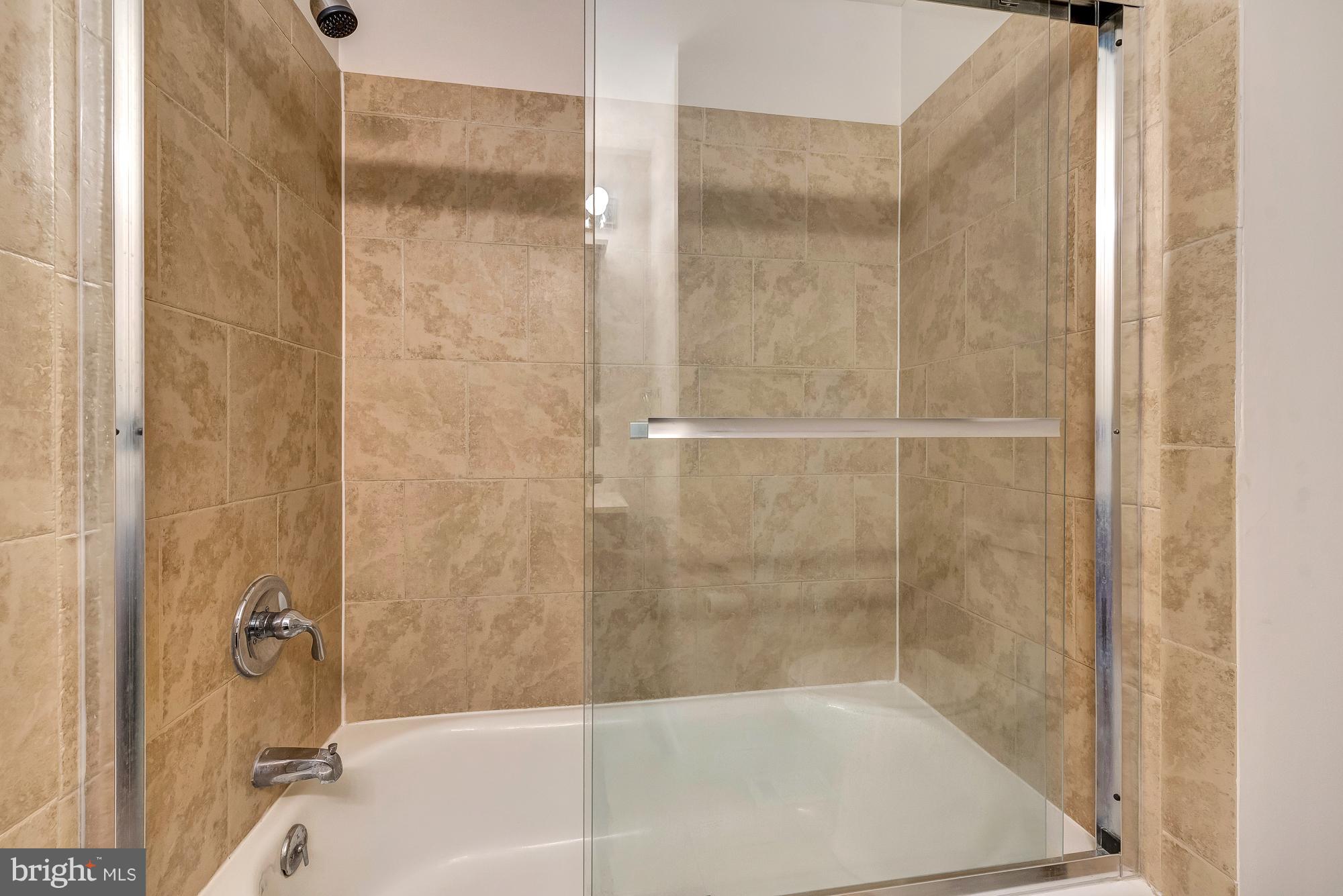 17624 Kohlhoss Road Poolesville, MD 20837 - Photo 25 of 36 a bathroom with a bathtub and a shower