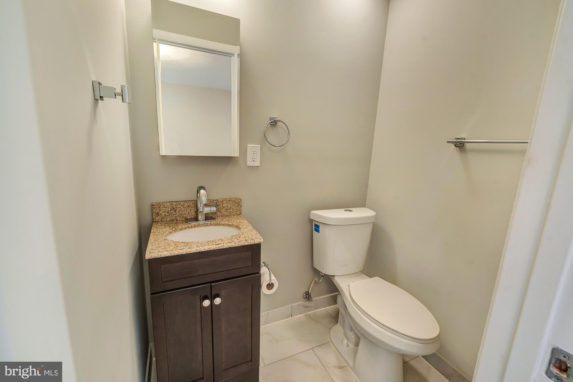 17624 Kohlhoss Road Poolesville, MD 20837 - Photo 29 of 36 a bathroom with a toilet sink and mirror