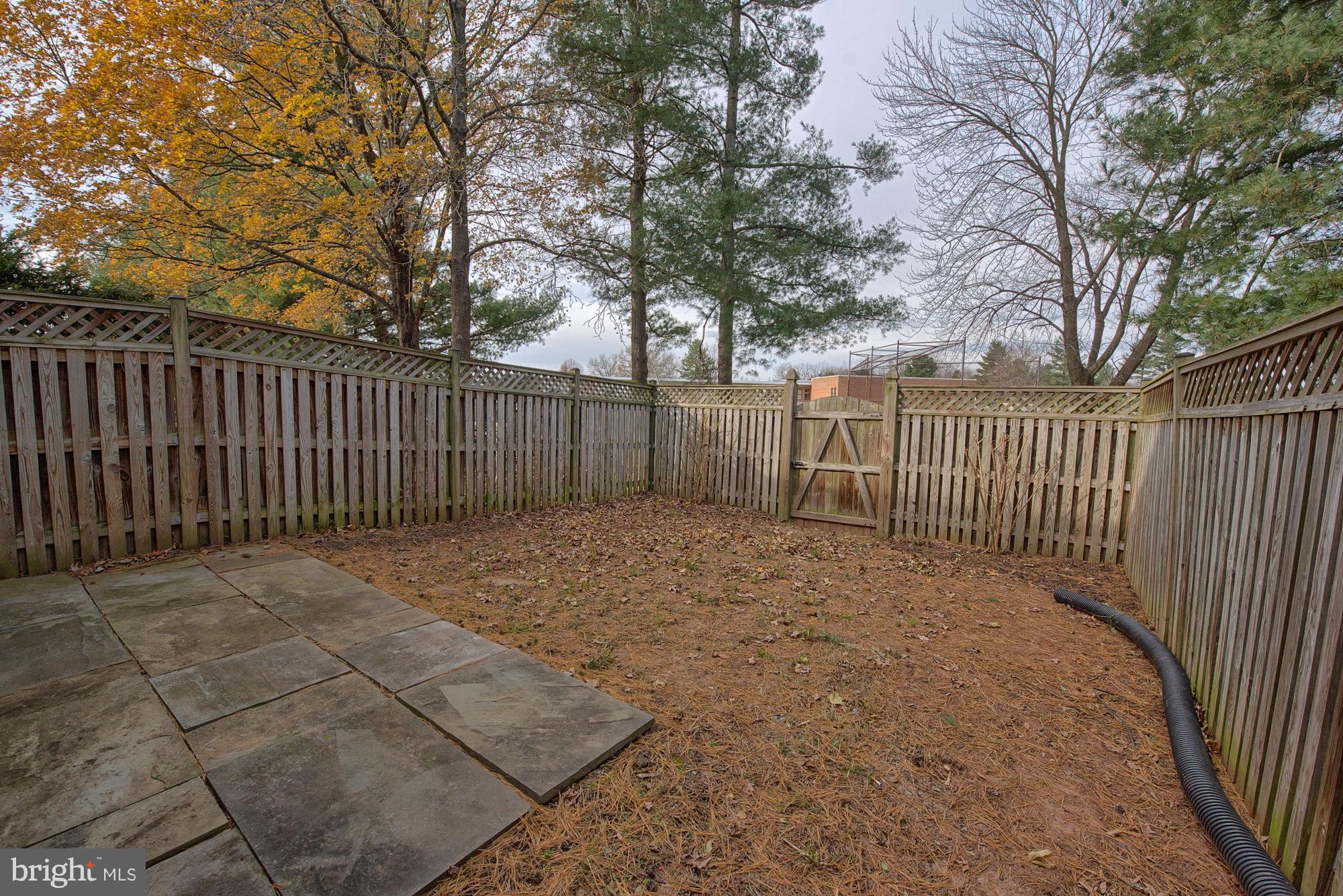17624 Kohlhoss Road Poolesville, MD 20837 - Photo 5 of 36 a view of backyard with wooden fence and large trees