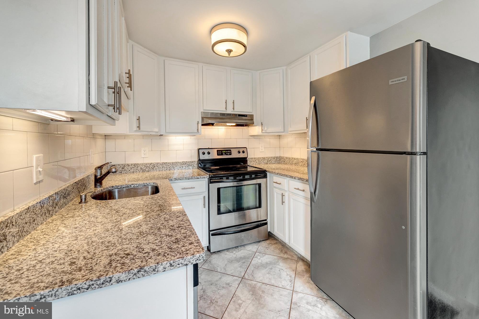 17624 Kohlhoss Road Poolesville, MD 20837 - Photo 10 of 36 a kitchen with granite countertop a refrigerator stove and sink