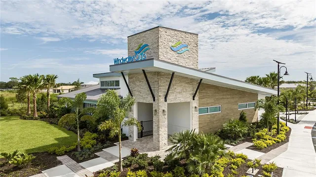 an aerial view of a house with swimming pool and outdoor seating