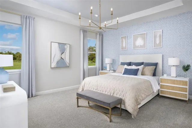 a bedroom with a bed and a lamp on dresser