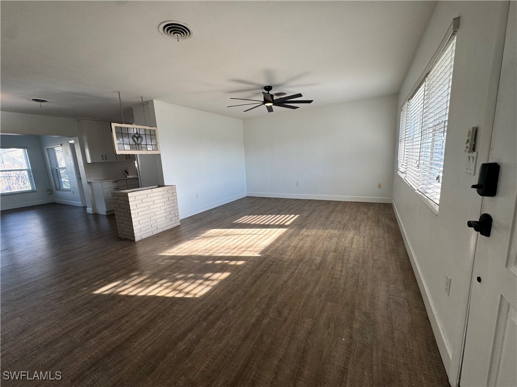 5521 Granada Road Fort Myers, FL 33919 - Photo 4 of 35 wooden floor in an empty room with a window