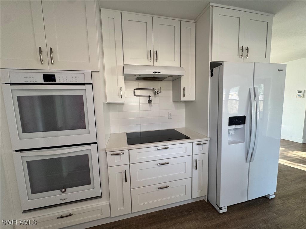 5521 Granada Road Fort Myers, FL 33919 - Photo 8 of 35 a kitchen with stainless steel appliances white cabinets and a refrigerator