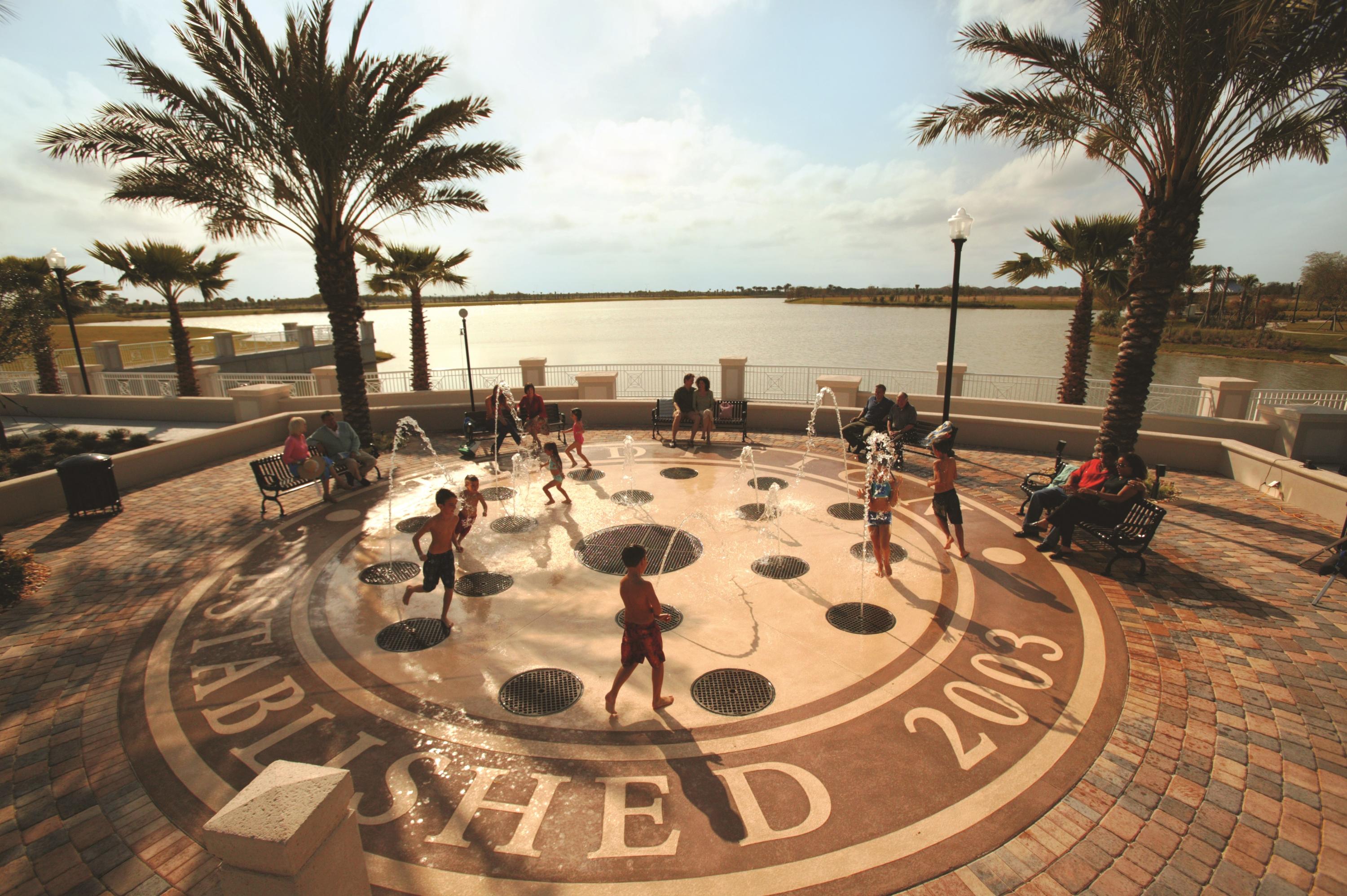 12348 Arabella Drive Port St. Lucie, FL 34987 - Photo 23 of 26 a view of a swimming pool with a table and chairs