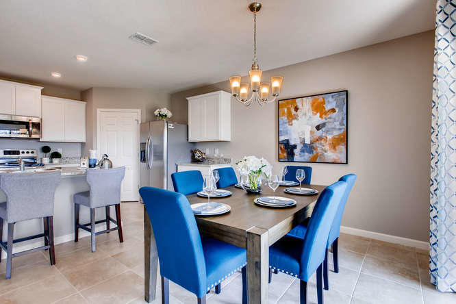 12348 Arabella Drive Port St. Lucie, FL 34987 - Photo 4 of 26 a view of a dining room with furniture a chandelier and wooden floor
