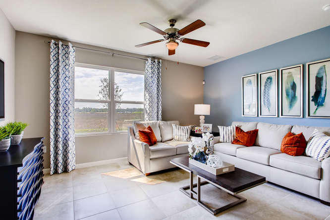 12348 Arabella Drive Port St. Lucie, FL 34987 - Photo 5 of 26 a living room with furniture and a large window with potted plants