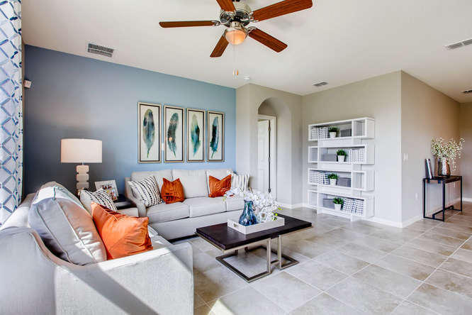 12348 Arabella Drive Port St. Lucie, FL 34987 - Photo 6 of 26 a living room with furniture a rug and a bookshelf