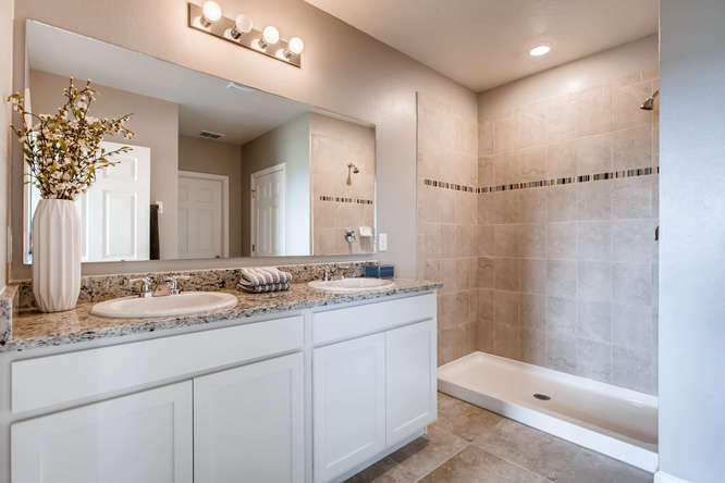 12348 Arabella Drive Port St. Lucie, FL 34987 - Photo 8 of 26 a bathroom with a double vanity sink toilet and shower