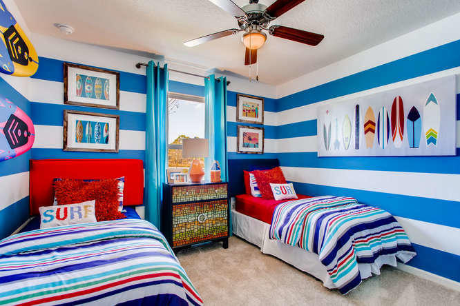 12348 Arabella Drive Port St. Lucie, FL 34987 - Photo 10 of 26 a bedroom with a bed and a book shelf