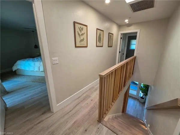 a view of entryway and hall with wooden floor