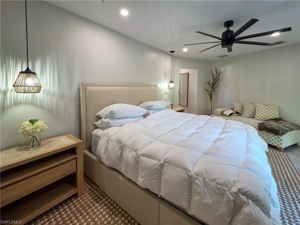 1495 Blue Point Avenue, Unit C Naples, FL 34102 - Photo 14 of 21 a bedroom with a bed and ceiling fan