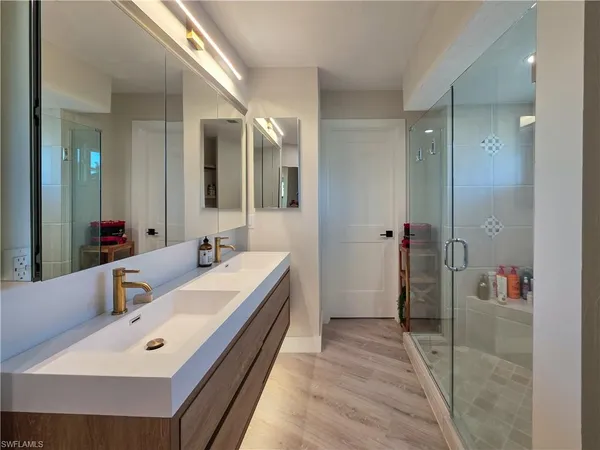 a bathroom with a tub sink and mirror