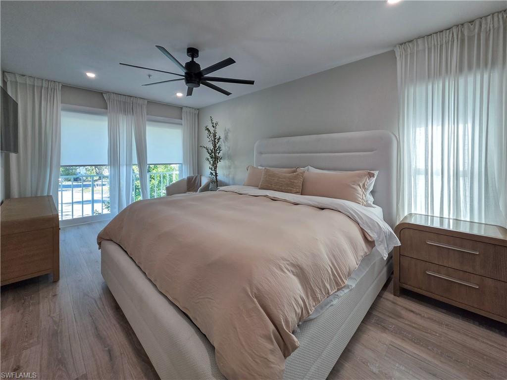 1495 Blue Point Avenue, Unit C Naples, FL 34102 - Photo 20 of 21 a bed sitting in a spacious bedroom next to a window