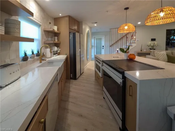 a kitchen with kitchen island a sink stove and cabinets
