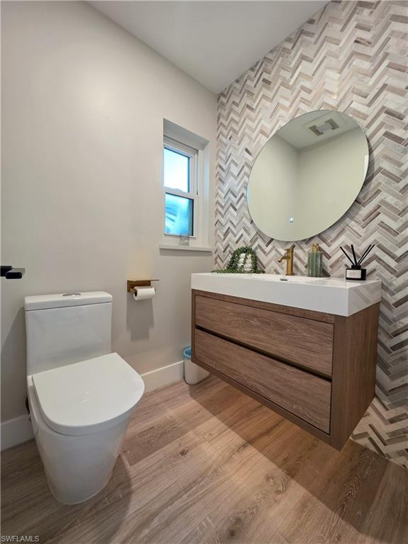 1495 Blue Point Avenue, Unit C Naples, FL 34102 - Photo 10 of 21 a bathroom with a sink mirror vanity and toilet