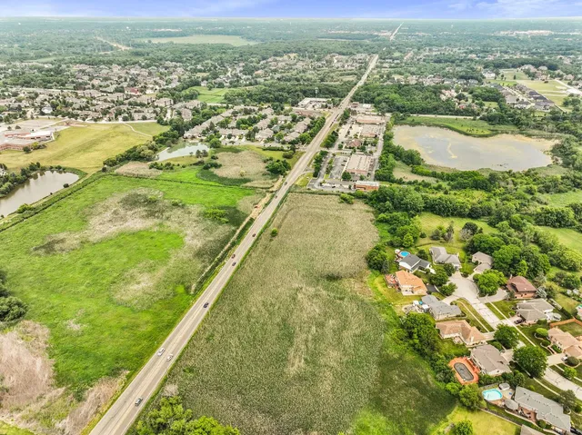 an aerial view of residential houses with outdoor space and river