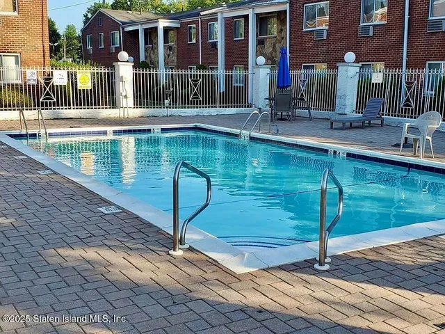 a swimming pool view with a outdoor seating