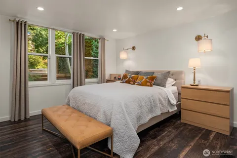 a bedroom with a bed and a night stand