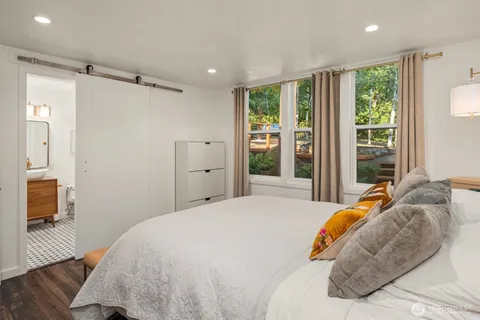 a bedroom with a bed and a large window