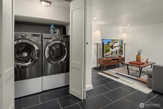 a living room with washing machine and a rug