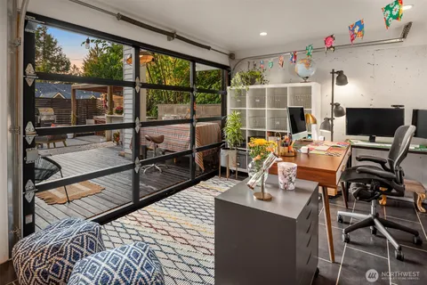 a view of a workspace with furniture and floor to ceiling window