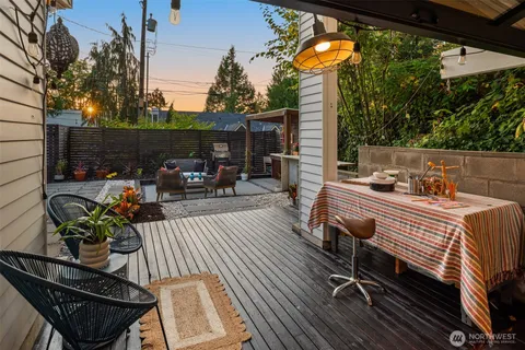 a view of a patio with couches table and chairs and potted plants