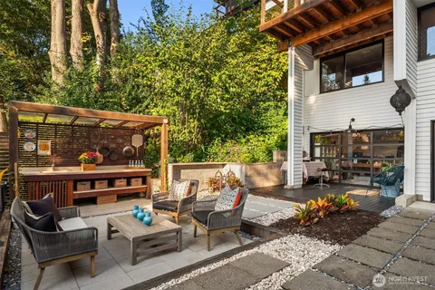 a view of a patio with couches table and chairs and potted plants