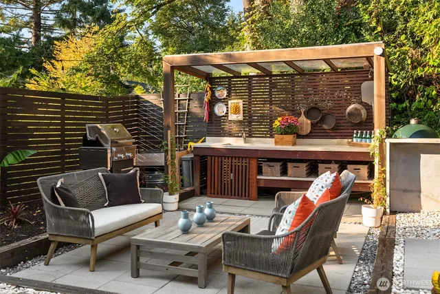 a view of a patio with couches table and chairs and potted plants