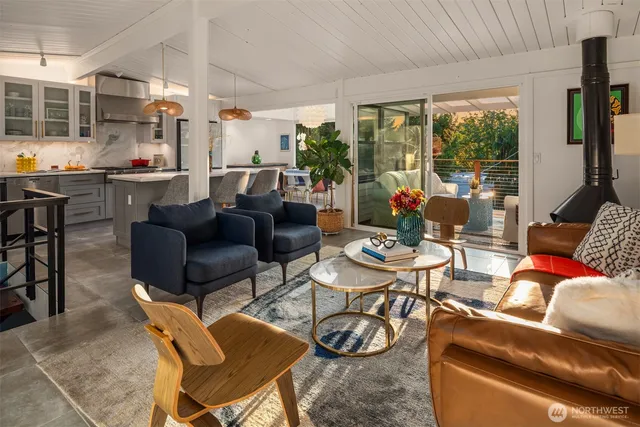 a living room with furniture and a floor to ceiling window