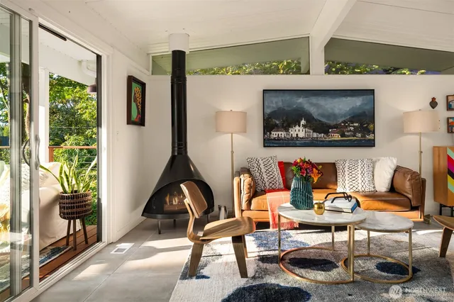 a living room with furniture and a painting on the wall