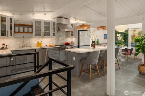 a kitchen with a table chairs sink and cabinets