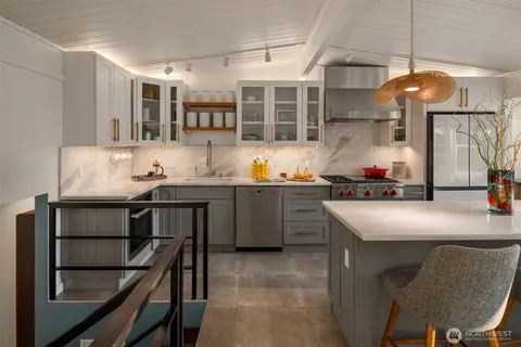 a kitchen with stainless steel appliances a sink and a stove