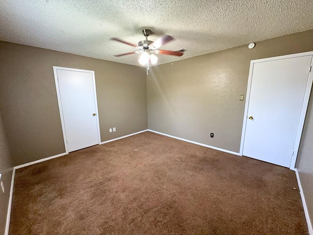 1613 Edgehill Road Benbrook, TX 76126 - Photo 13 of 22 an empty room with a chandelier fan and windows