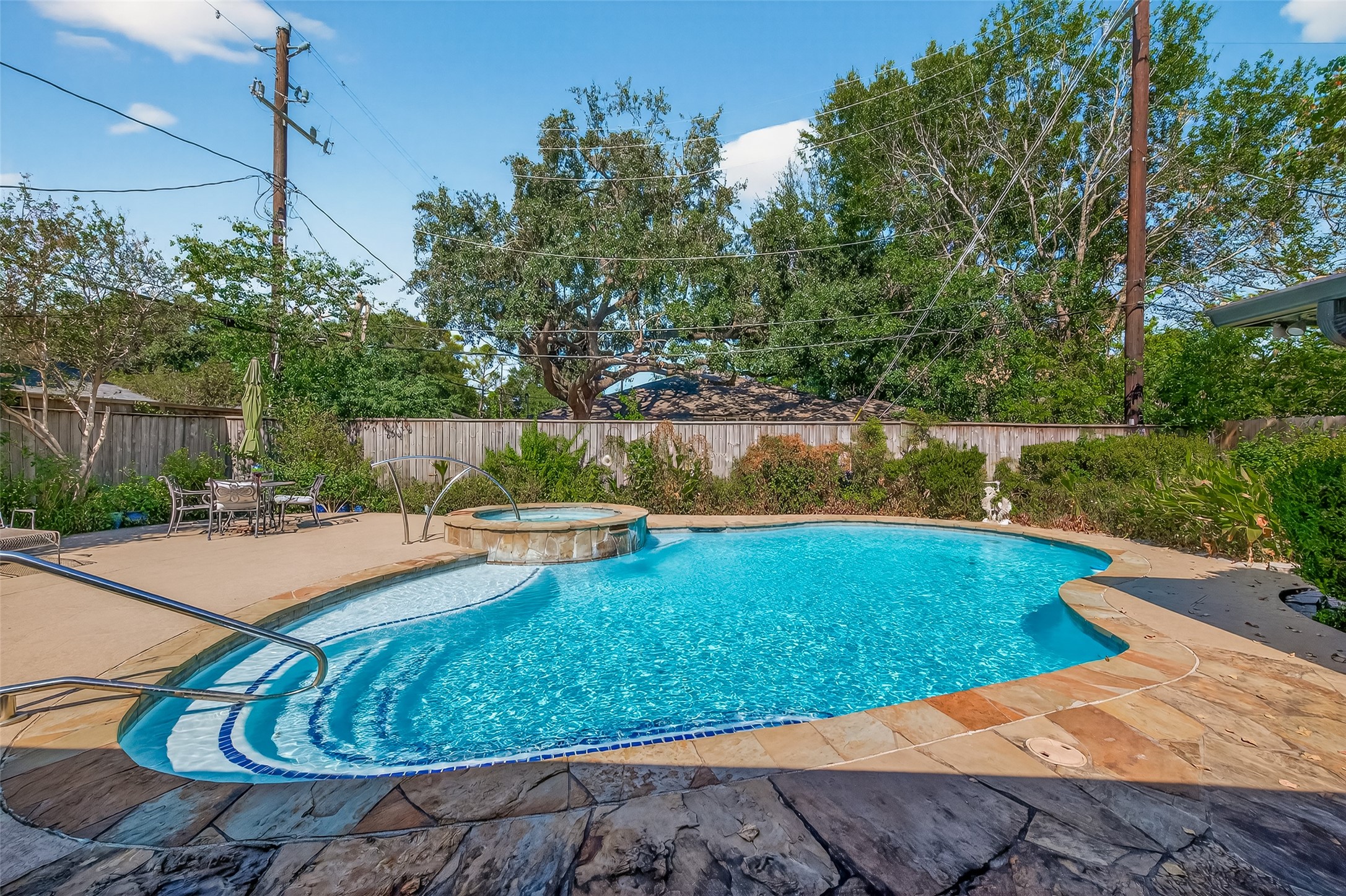 a view of a swimming pool with a yard and a fountain