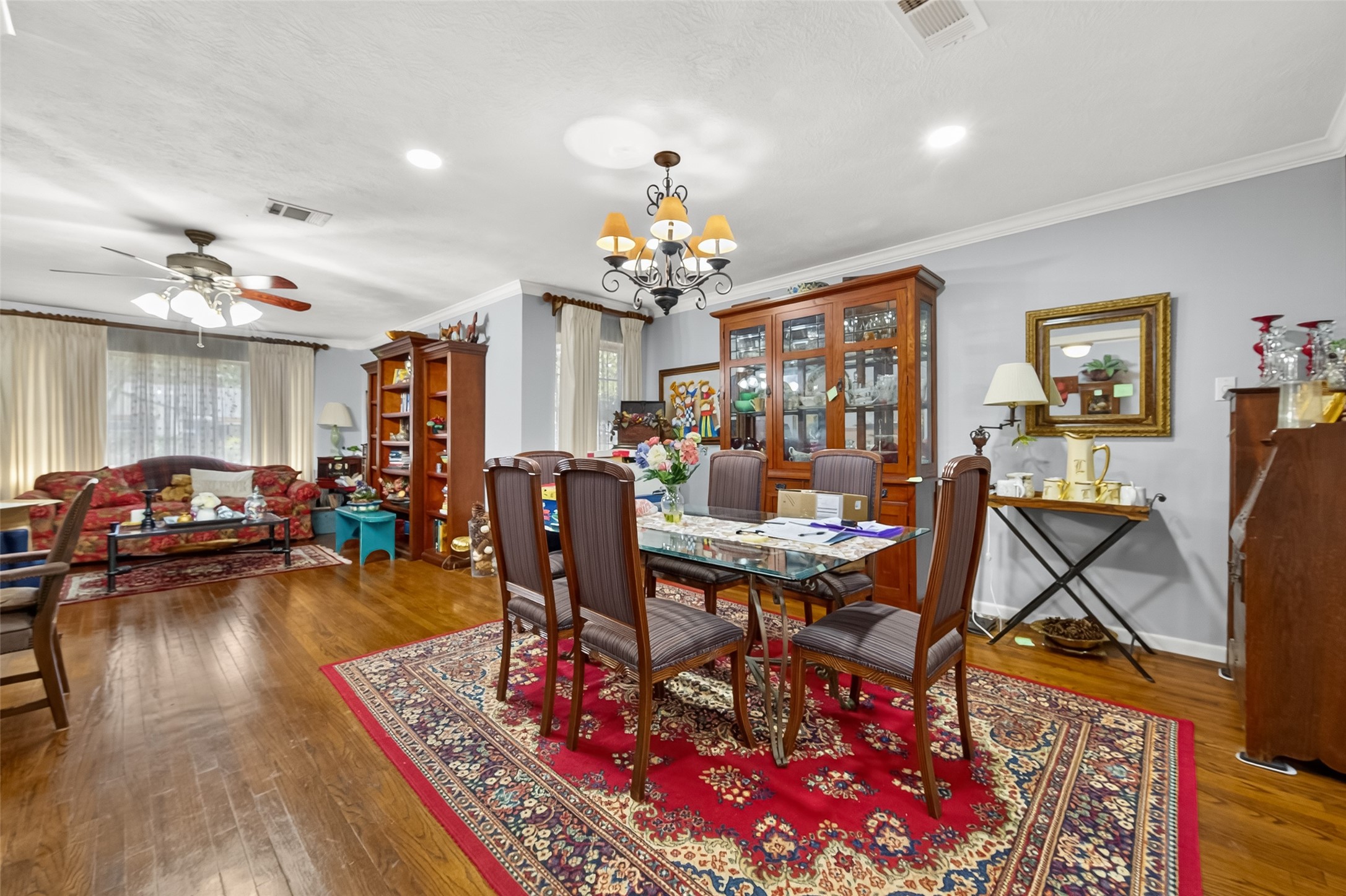 5326 Redstart Street Houston, TX 77096 - Photo 13 of 41 a living room with furniture a dining table and a chandelier