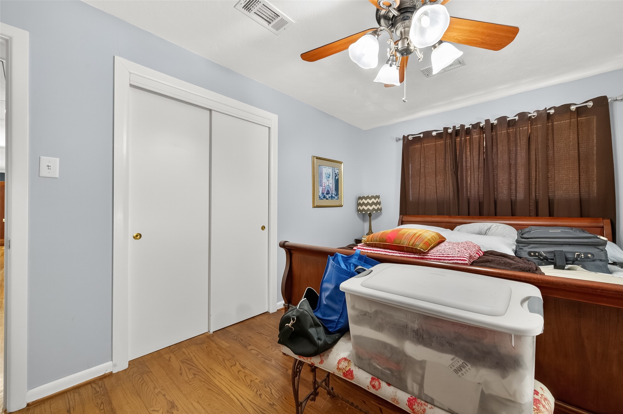 5326 Redstart Street Houston, TX 77096 - Photo 24 of 41 a bedroom with a bed and a chandelier