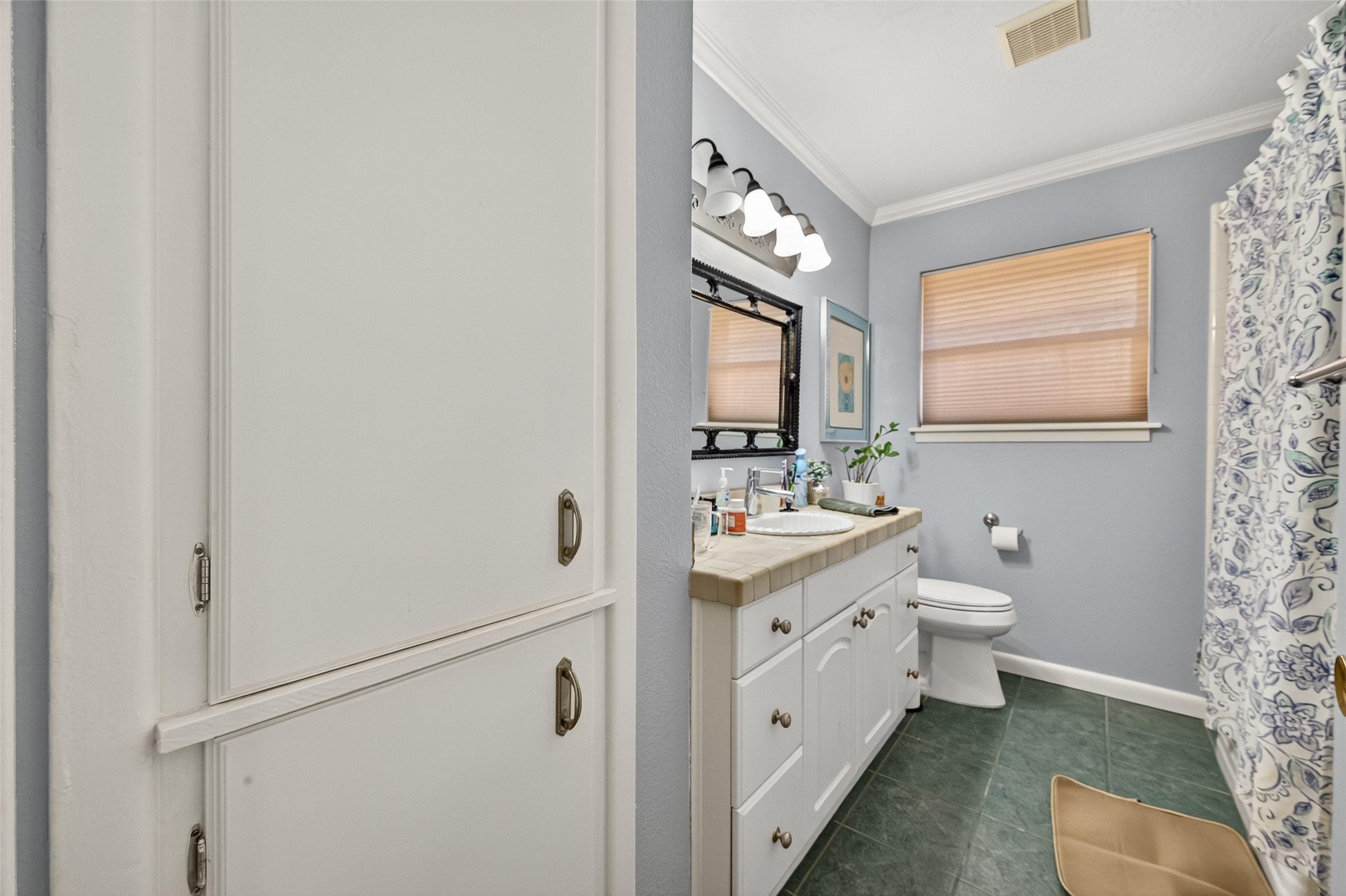 5326 Redstart Street Houston, TX 77096 - Photo 25 of 41 a bathroom with a double vanity sink toilet and mirror