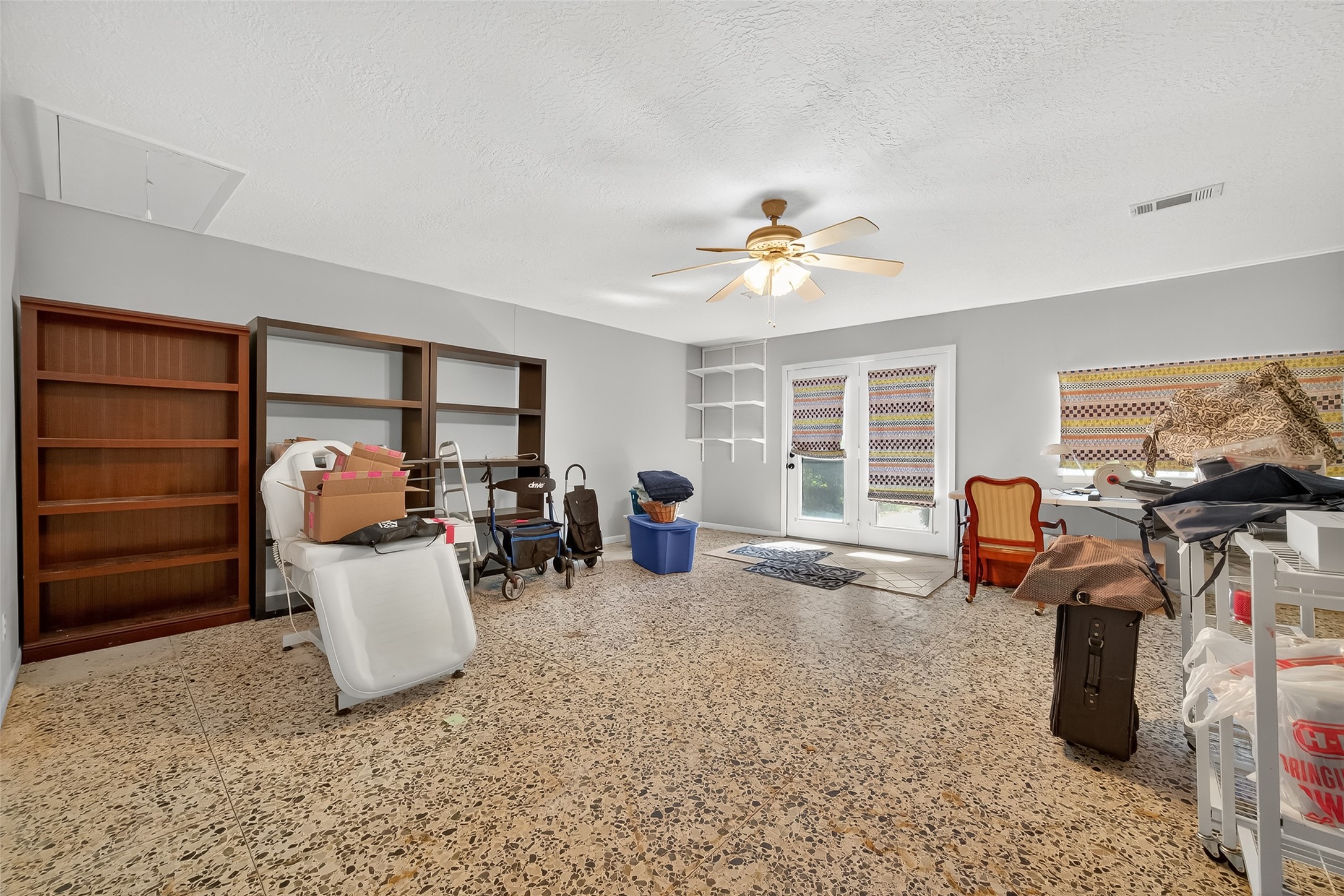 5326 Redstart Street Houston, TX 77096 - Photo 29 of 41 a living room with furniture a ceiling fan chandelier and a window